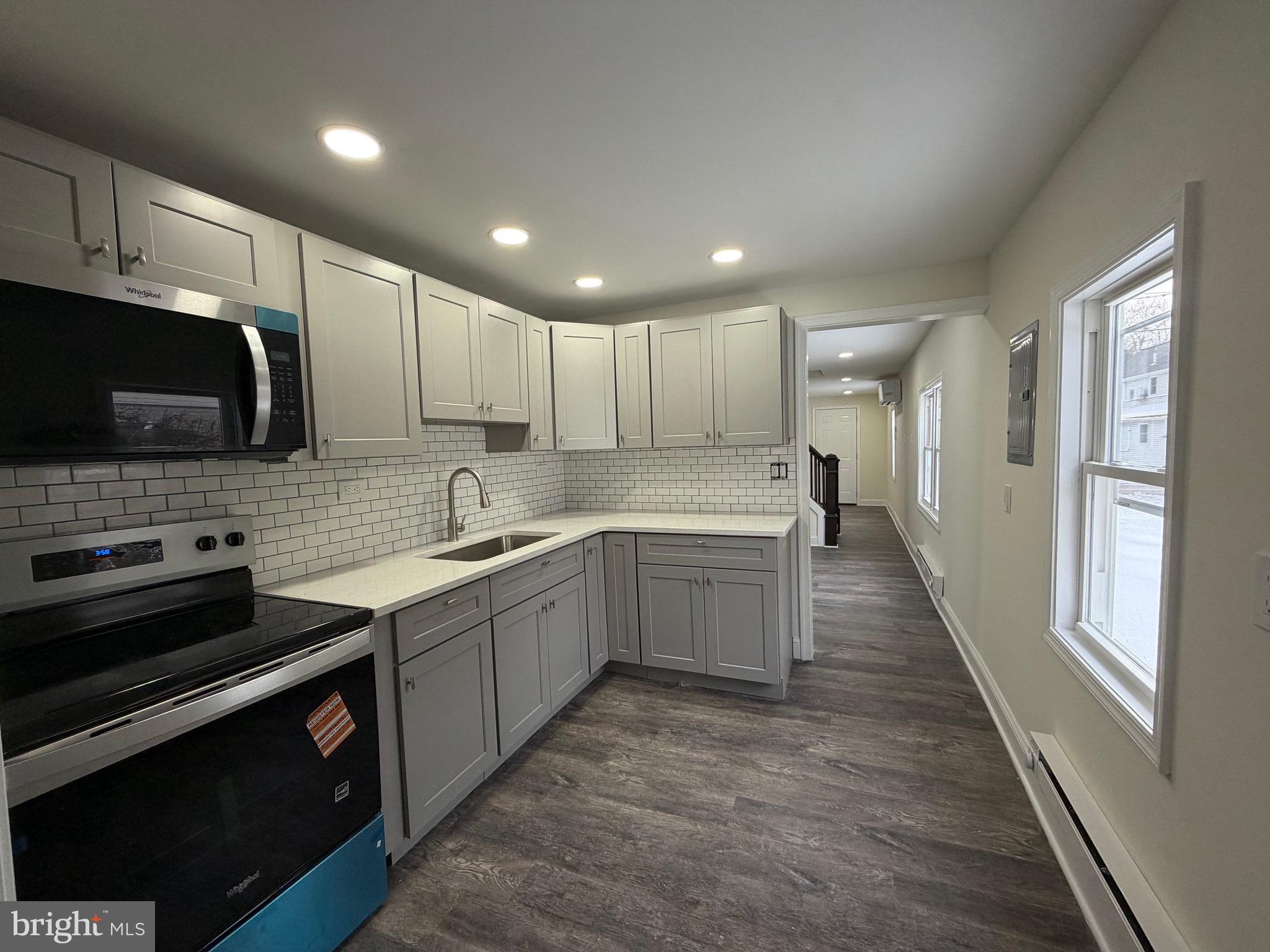 197 Main Street Hartly, DE 19953 - Photo 8 of 17 a large kitchen with stainless steel appliances granite countertop a stove a sink and a microwave