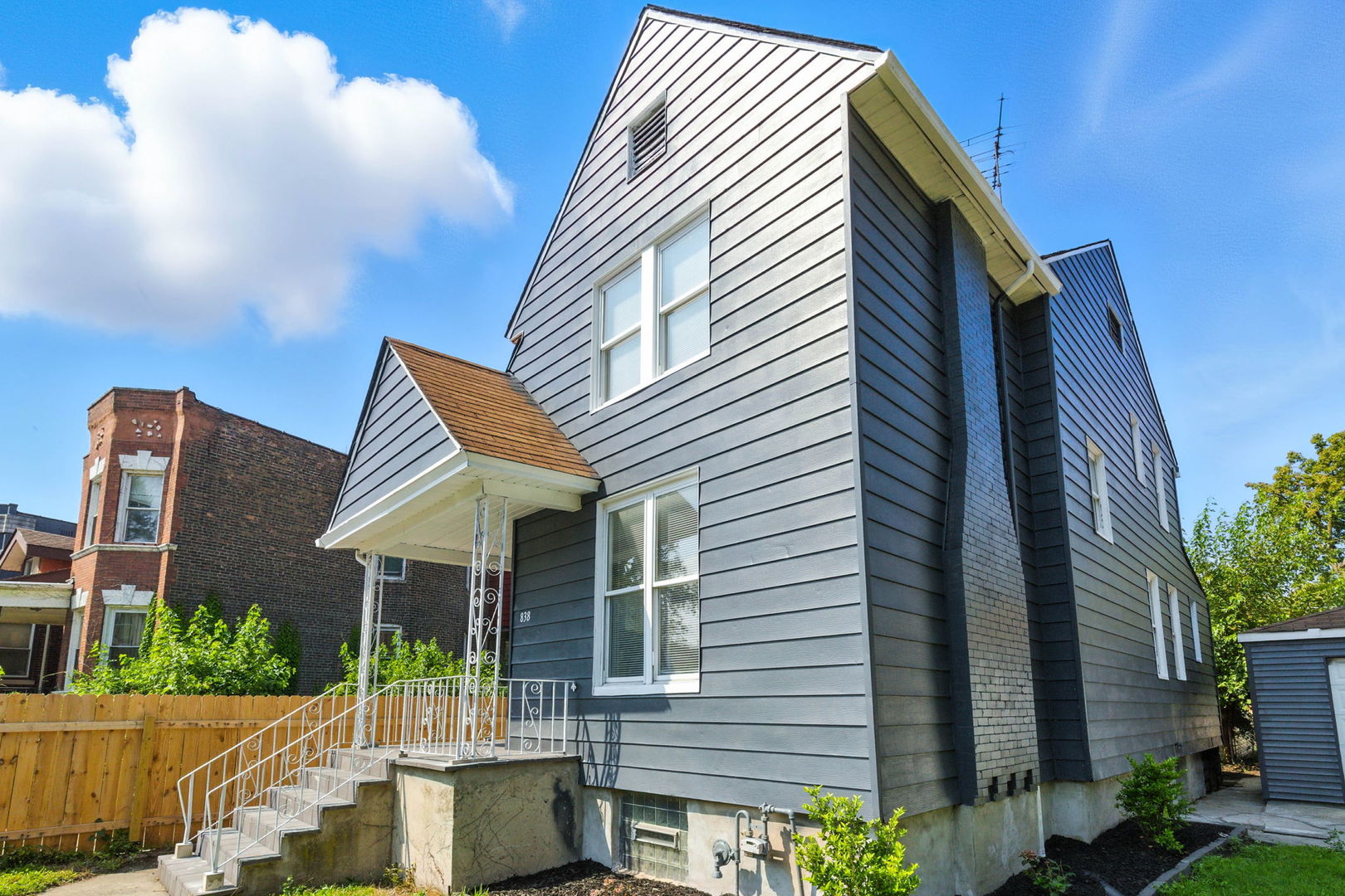 a view of a house with backyard and sitting area