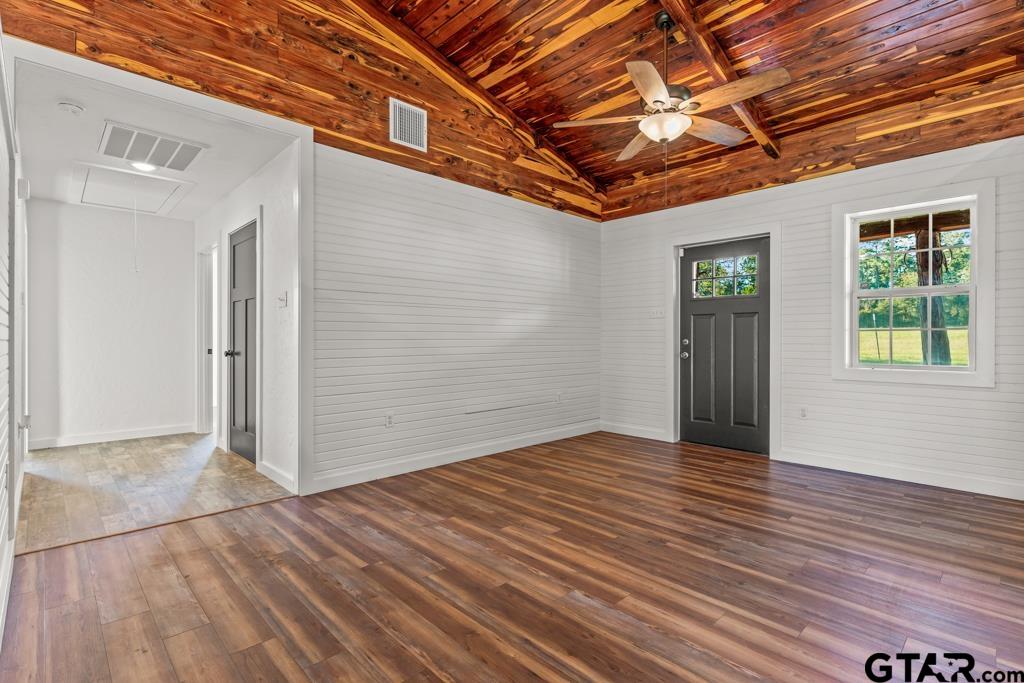 3400 Pony Road Gilmer, TX 75644 - Photo 3 of 46 an empty room with wooden floor and windows