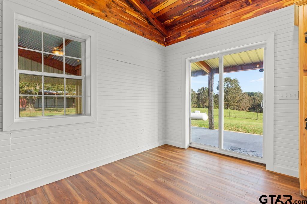 3400 Pony Road Gilmer, TX 75644 - Photo 8 of 46 a view of an empty room with wooden floor and a window