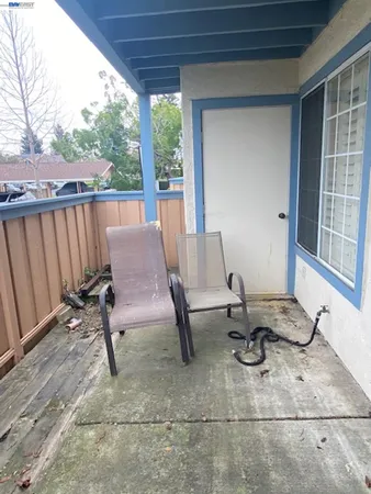 a view of a patio with wooden floor and chairs