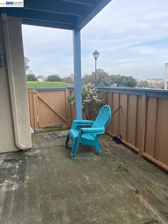 a blue bench sitting in the middle of a field
