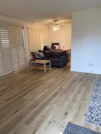 a room with wooden floor and furniture