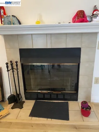 a room with a fireplace and cabinets