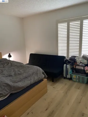 a bedroom with a bed and a couch