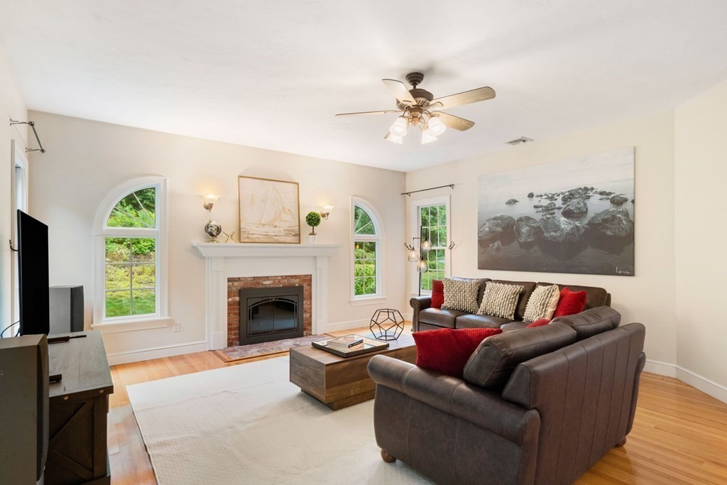 21 Guide Post Pth Path Marshfield, MA 02050 - Photo 11 of 34 a living room with furniture and a fireplace