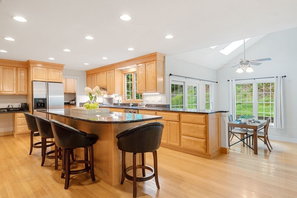 21 Guide Post Pth Path Marshfield, MA 02050 - Photo 5 of 34 a kitchen with stainless steel appliances granite countertop dining table chairs refrigerator and sink