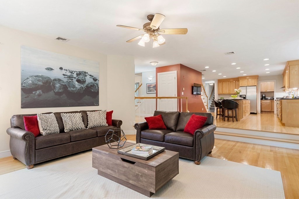 21 Guide Post Pth Path Marshfield, MA 02050 - Photo 10 of 34 a living room with furniture kitchen view and a chandelier