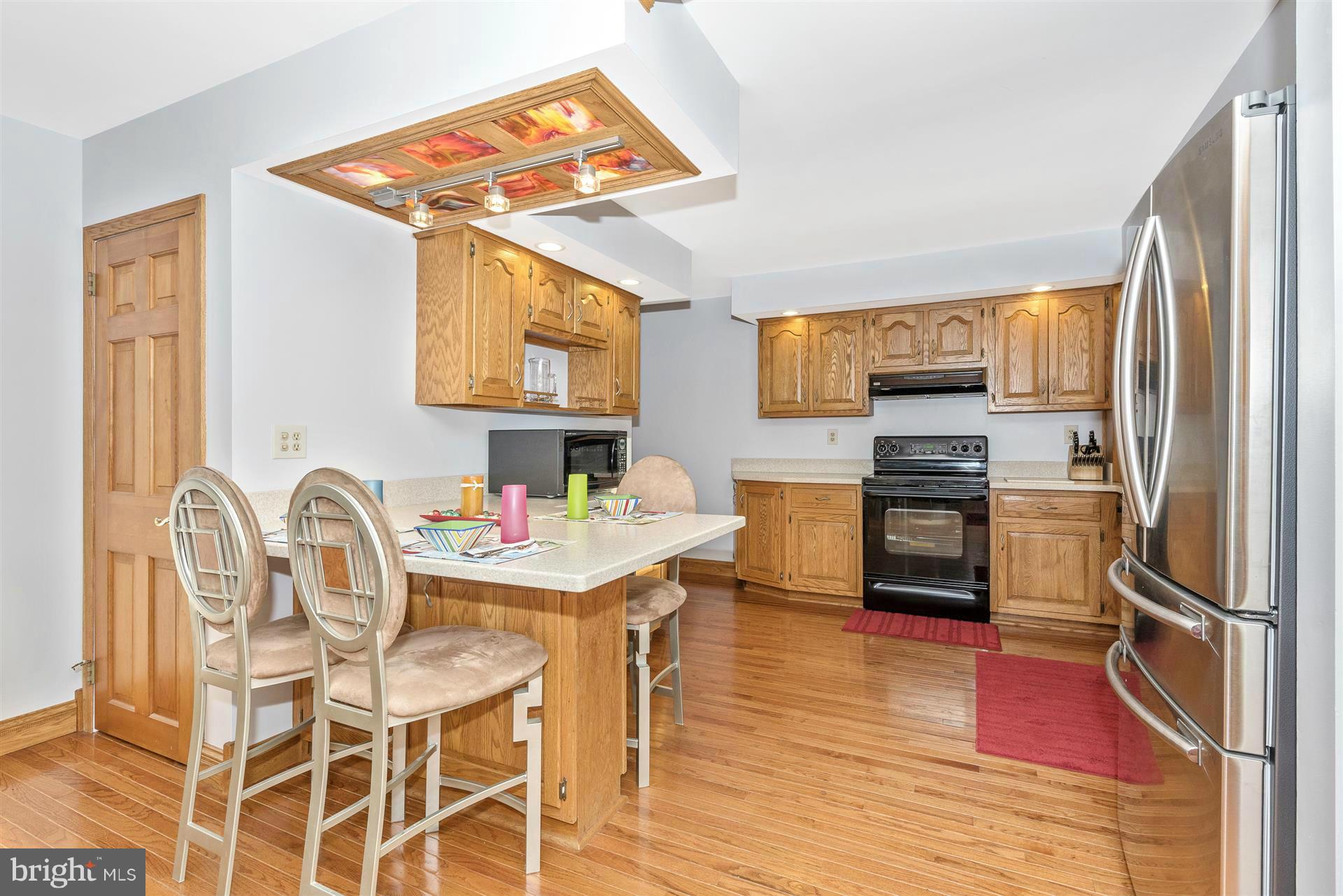 2512 Braddock Road Mount Airy, MD 21771 - Photo 8 of 30 a kitchen with stainless steel appliances a stove a refrigerator and a dining table