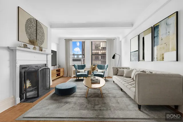 a living room with furniture a fireplace and a large window