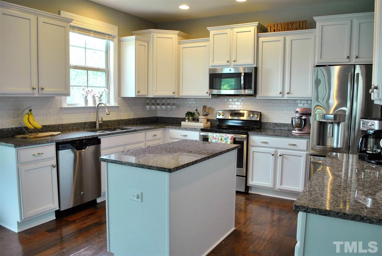 100 Maraketch Court Raleigh, NC 27603 - Photo 3 of 22 a kitchen with a sink stove top oven and refrigerator