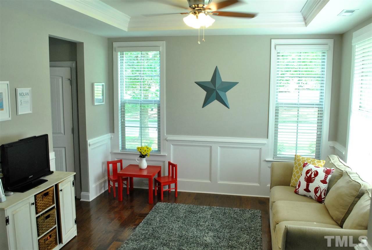 100 Maraketch Court Raleigh, NC 27603 - Photo 4 of 22 a living room with furniture and a flat screen tv