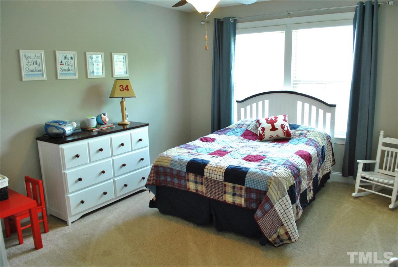 100 Maraketch Court Raleigh, NC 27603 - Photo 6 of 22 a bedroom with a bed and a dresser