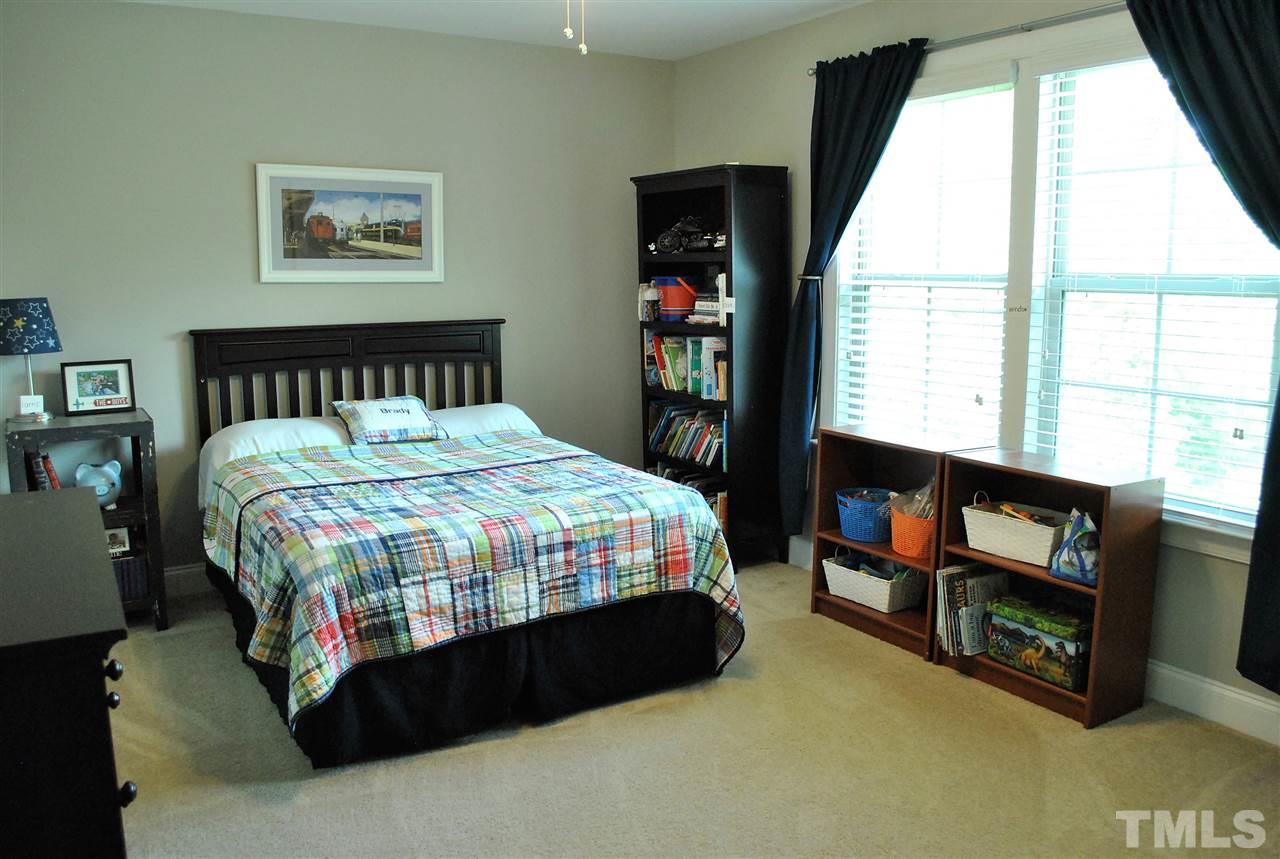 100 Maraketch Court Raleigh, NC 27603 - Photo 7 of 22 a bedroom with a bed a dresser and a large window