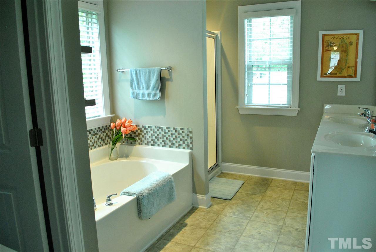 100 Maraketch Court Raleigh, NC 27603 - Photo 8 of 22 a bathroom with a tub sink and mirror