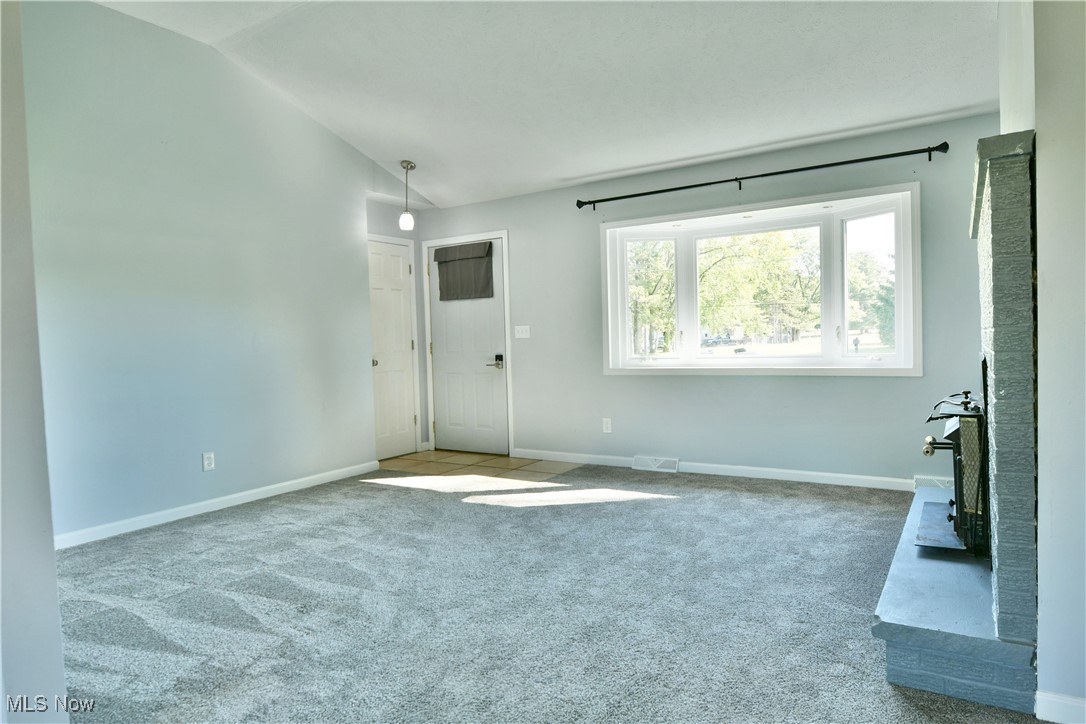 4461 Ridge Road Cortland, OH 44410 - Photo 10 of 47 Carpeted empty room featuring vaulted ceiling