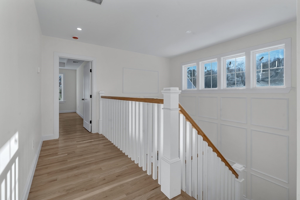 25 Columbine Road Rehoboth, MA 02769 - Photo 18 of 42 a view of a hallway with wooden floor and staircase