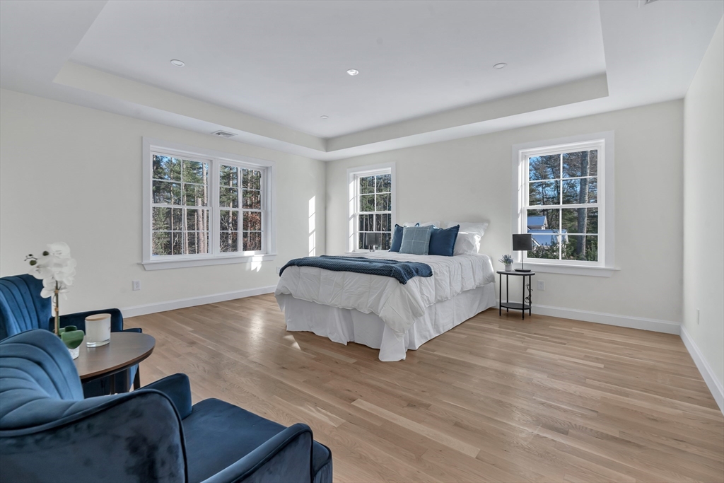 25 Columbine Road Rehoboth, MA 02769 - Photo 19 of 42 a spacious bedroom with a bed couch and window