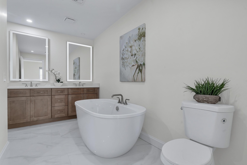 25 Columbine Road Rehoboth, MA 02769 - Photo 21 of 42 a white bath tub sitting next to a white toilet