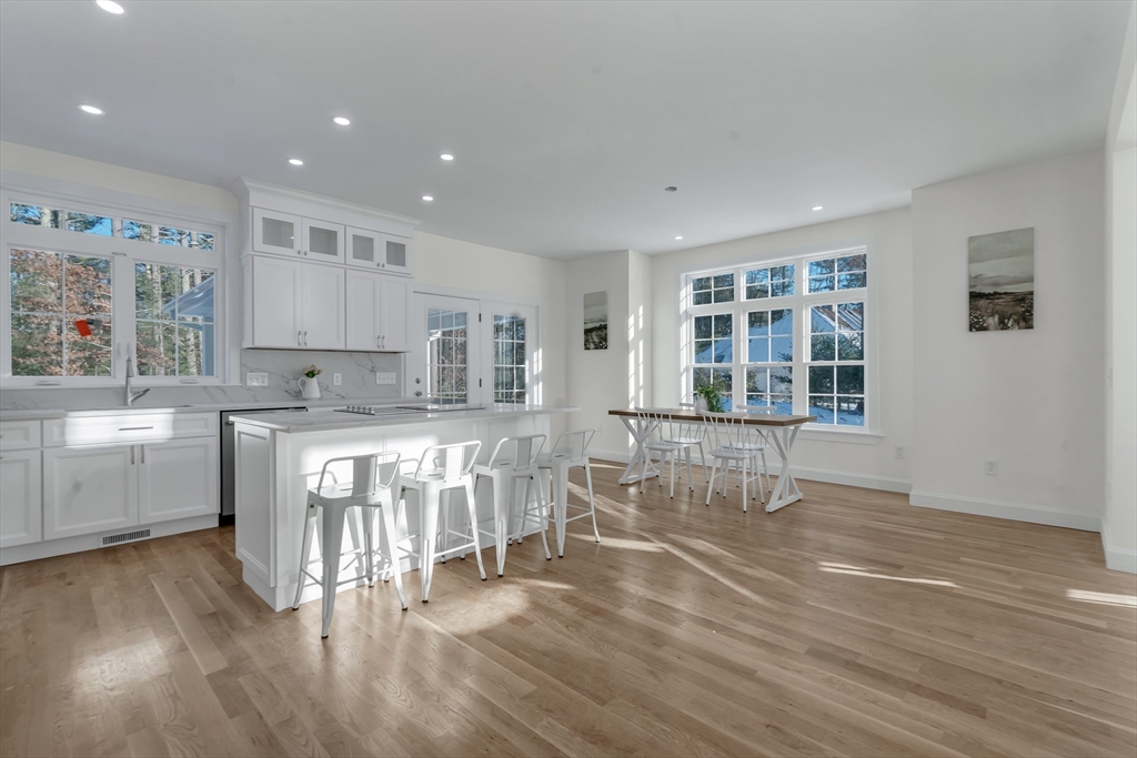 25 Columbine Road Rehoboth, MA 02769 - Photo 8 of 42 a kitchen with a table chairs a refrigerator and cabinets