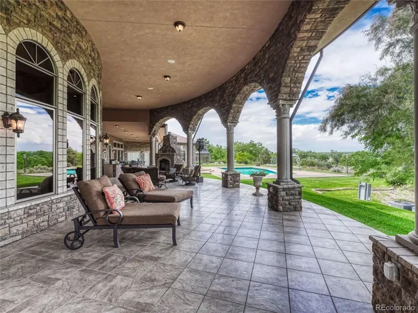 a view of a patio with table and chairs and potted plants