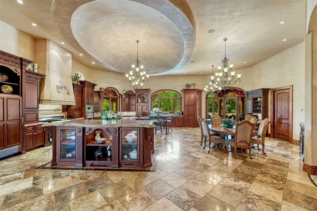 a living room with furniture a chandelier and a fireplace