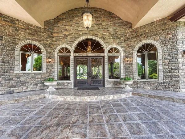 a living room with furniture gym equipment and a chandelier