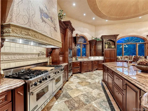 a kitchen with stainless steel appliances granite countertop a stove and a sink