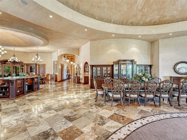 a living room with furniture a chandelier and a fireplace
