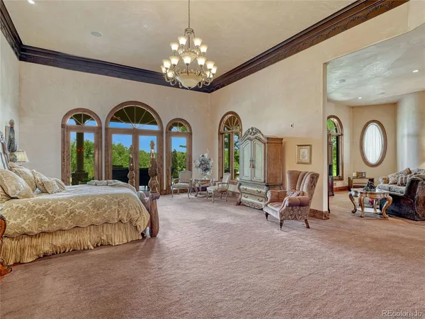 a spacious bedroom with bed and a large mirror