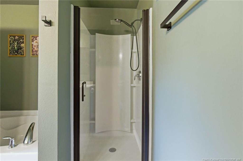334 Crane Way Bunnlevel, NC 28323 - Photo 32 of 45 a bathroom with a shower and a sink