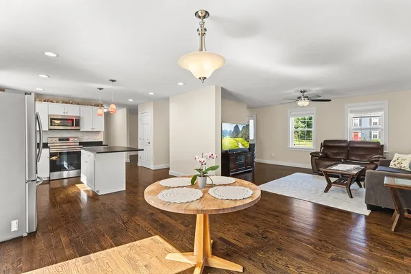 a living room with fireplace furniture and a wooden floor