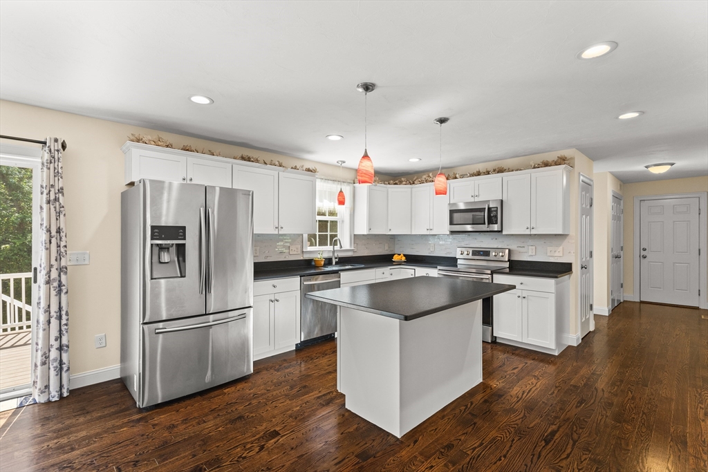 15 Carlton Street Raynham, MA 02767 - Photo 13 of 34 a kitchen with a refrigerator a sink and a microwave