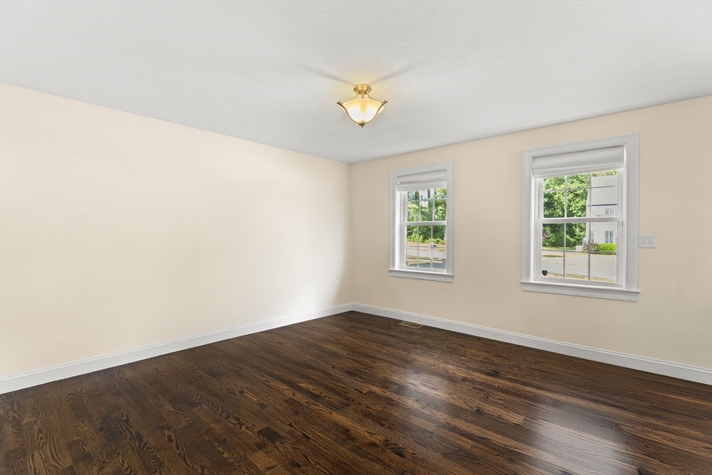 15 Carlton Street Raynham, MA 02767 - Photo 18 of 34 an empty room with wooden floor and windows