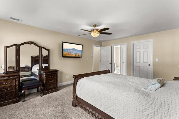 a bedroom with a bed and a chandelier