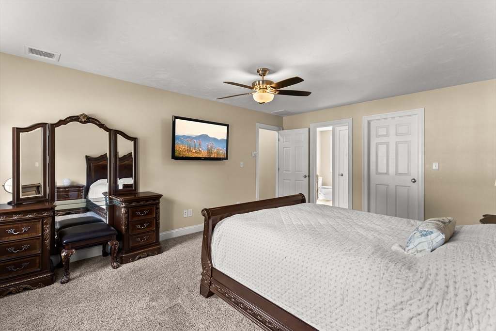 15 Carlton Street Raynham, MA 02767 - Photo 23 of 34 a bedroom with a bed and a chandelier