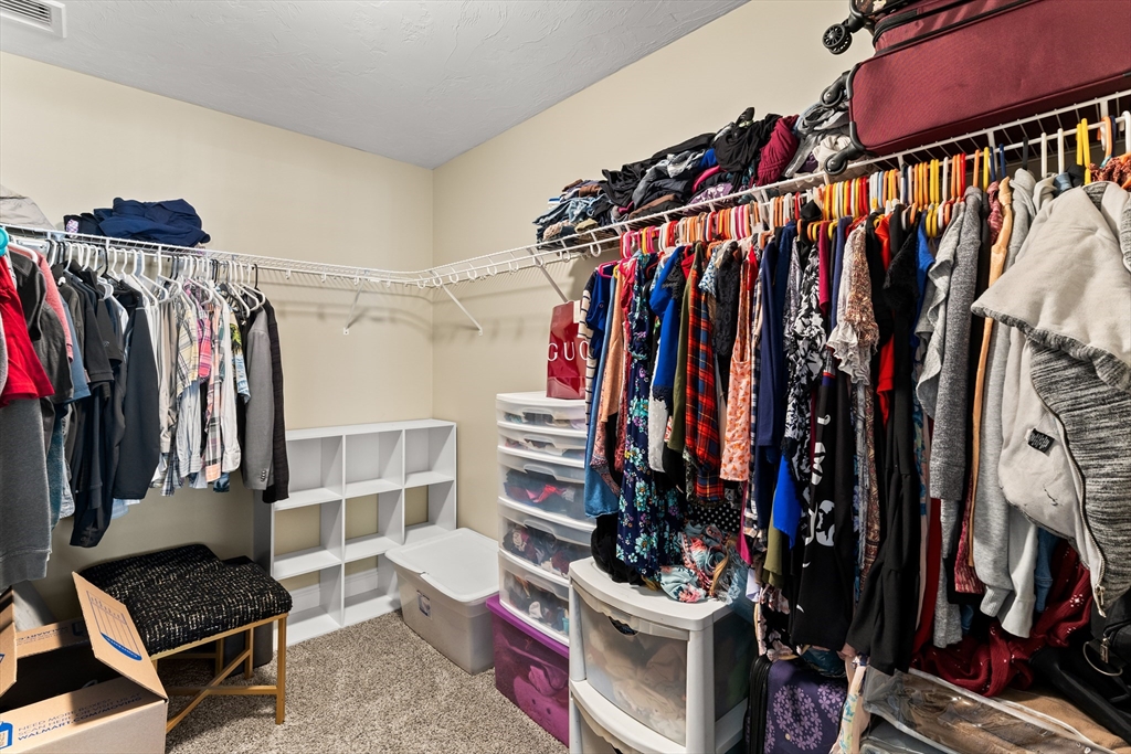 15 Carlton Street Raynham, MA 02767 - Photo 26 of 34 a view of walk in closet with clothes and shoes