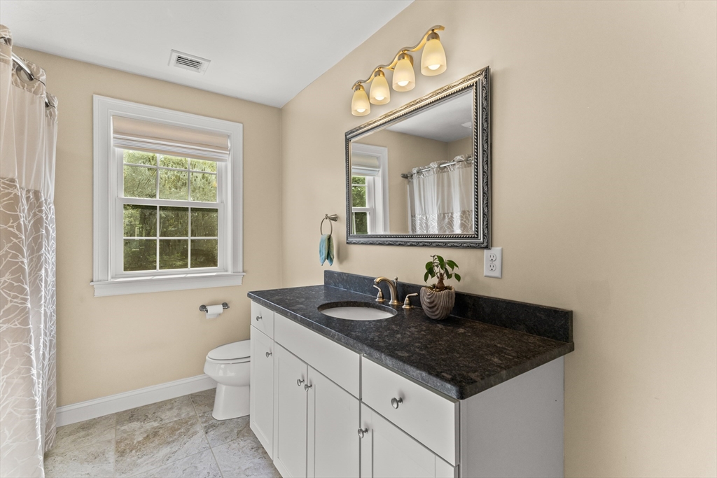 15 Carlton Street Raynham, MA 02767 - Photo 28 of 34 a bathroom with a granite countertop sink and a window