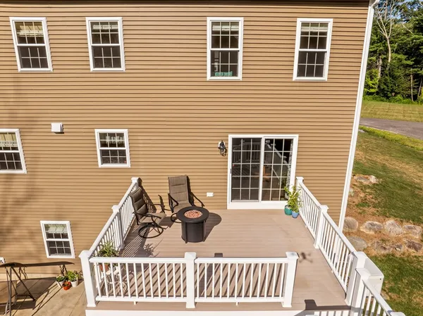 a view of a house with a patio and wooden fence