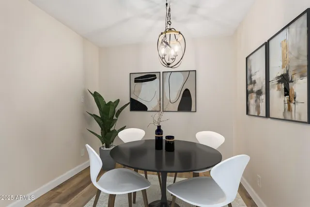 a kitchen with stainless steel appliances white cabinets and a stove a oven with wooden floor