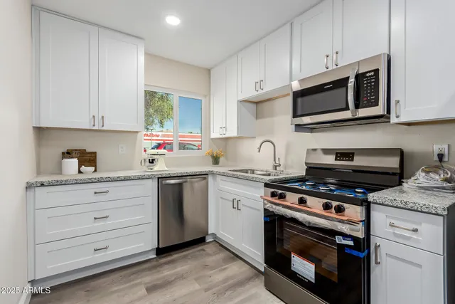 a bedroom with a bed and painting on the wall