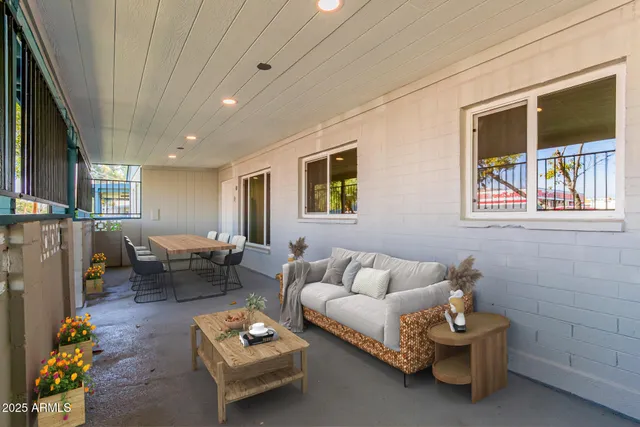 a view of a house with a yard and large tree