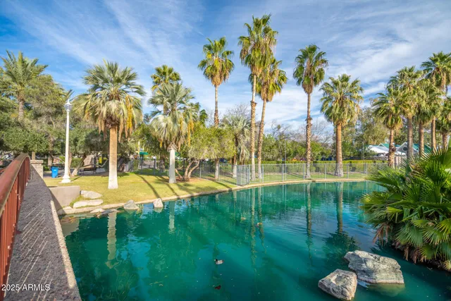 a view of yard with swimming pool and green space