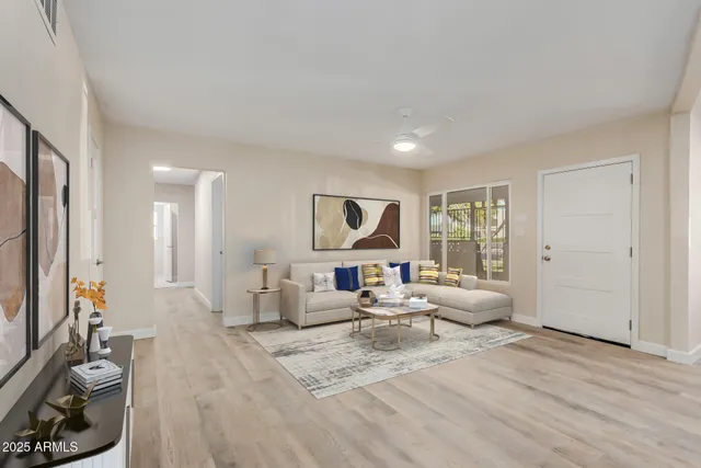 a living room with furniture and kitchen view
