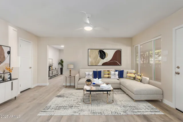 a living room with furniture and kitchen view