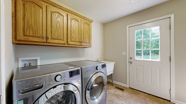 a view of a house with a yard and floor to ceiling window