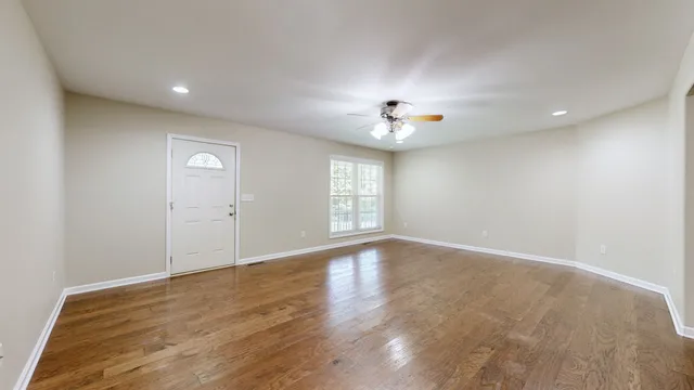 a kitchen with stainless steel appliances granite countertop a sink a stove and a wooden floors