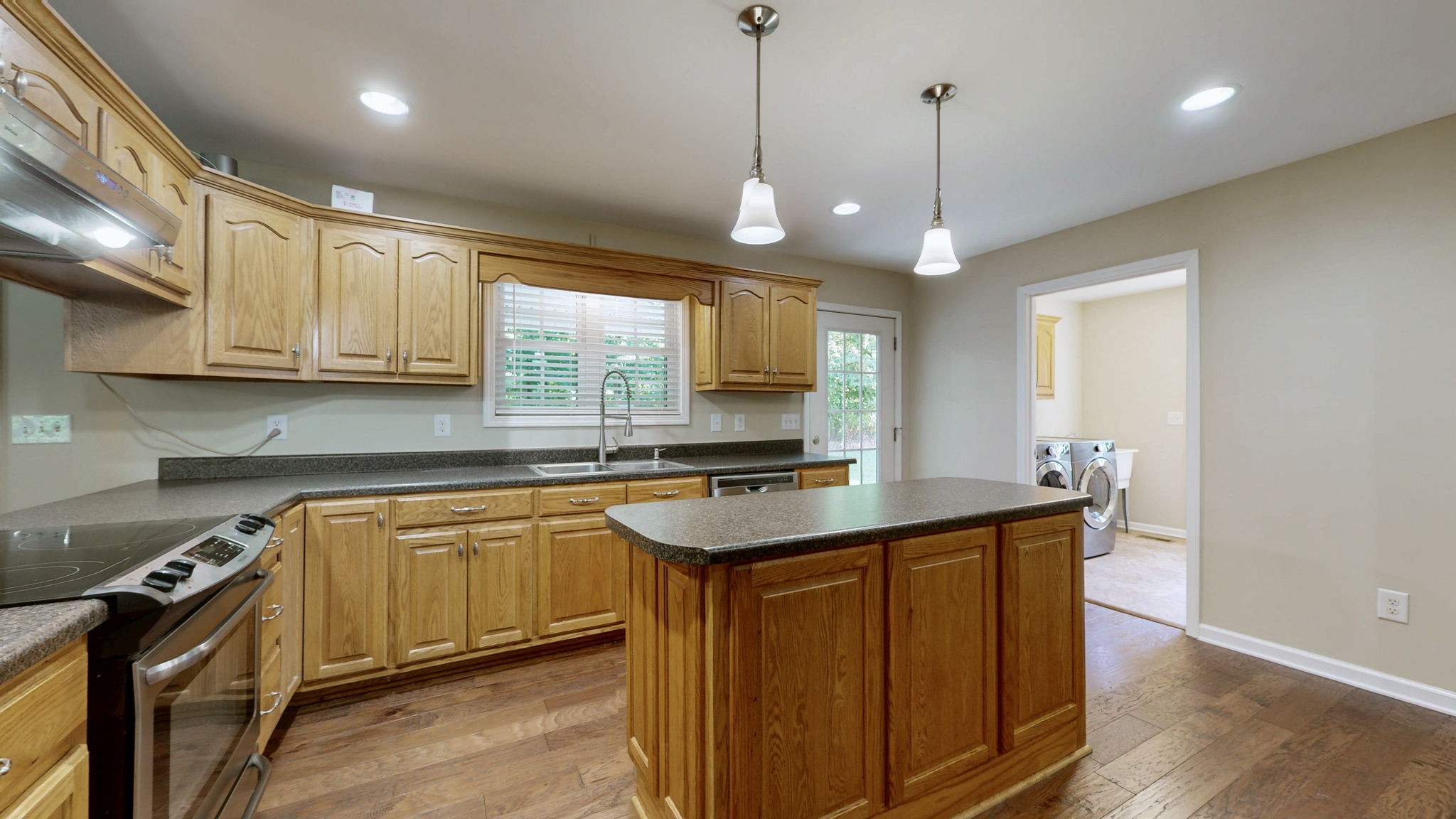 5430 Wiley Hollow Road Culleoka, TN 38451 - Photo 10 of 54 a kitchen with stainless steel appliances granite countertop a sink a stove and a wooden floors