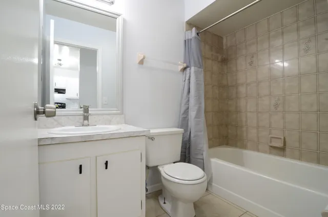a white bath tub sitting next to a white toilet and sink