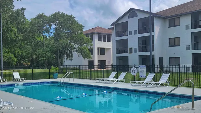 a view of a house with swimming pool and sitting area